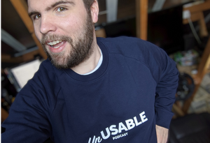 Podcast host Andrew wearing a dark blue Unusable Podcast sweatshirt