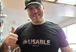 Podcast listener wearing a black Unusable Podcast t-shirt